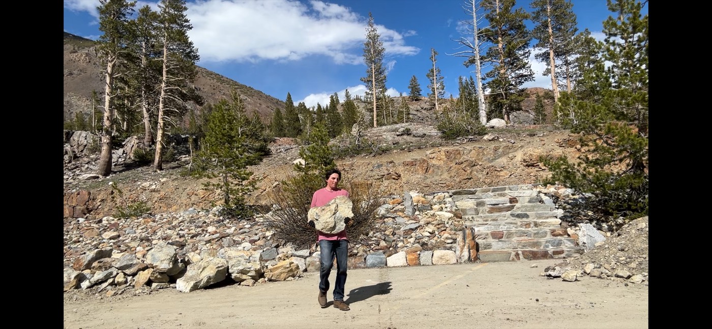 Adrian carrying stones